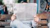 man reads newspaper